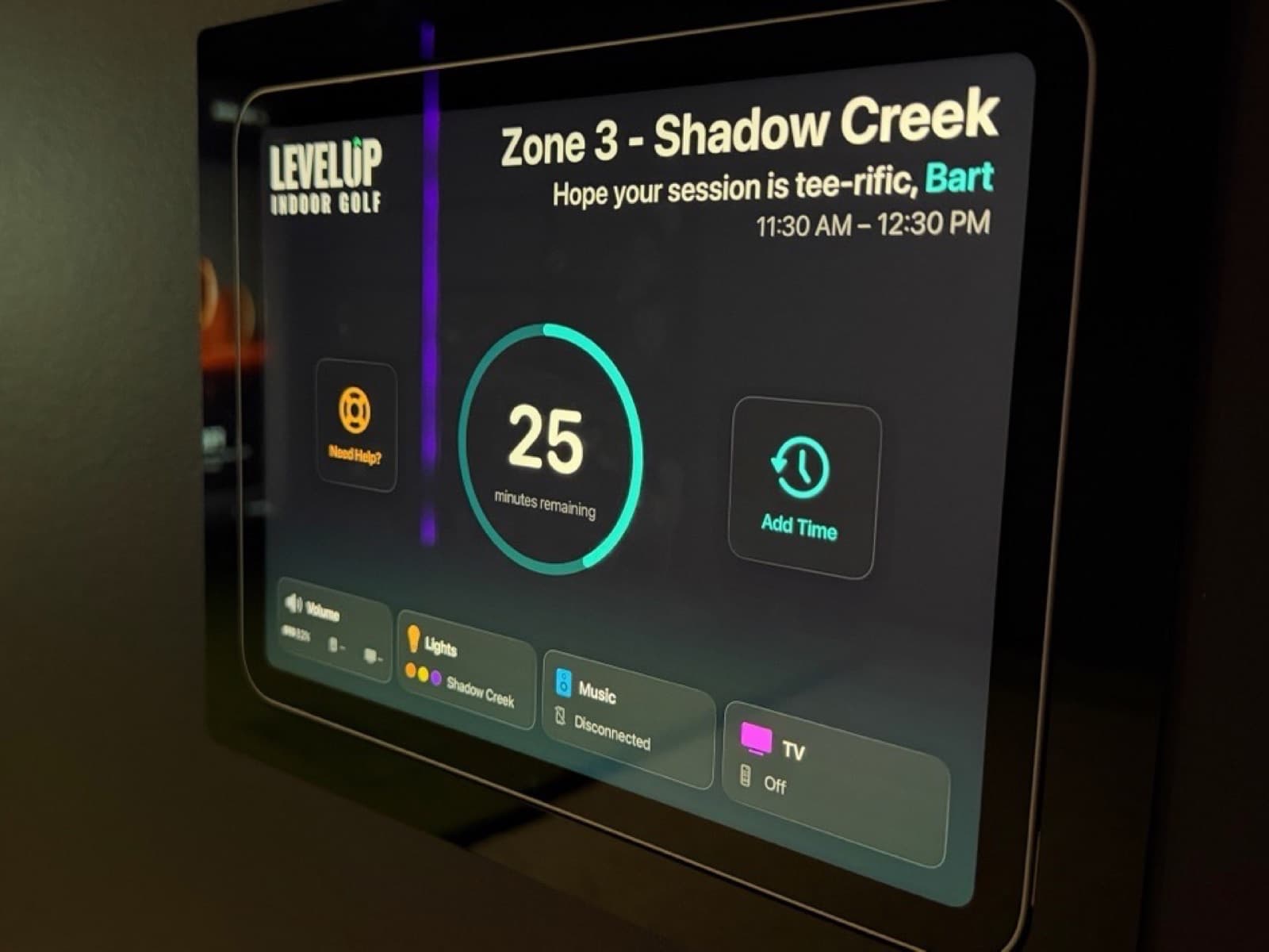 The in-bay ZoneLink iPad showing session time remaining and lighting, music, and TV controls