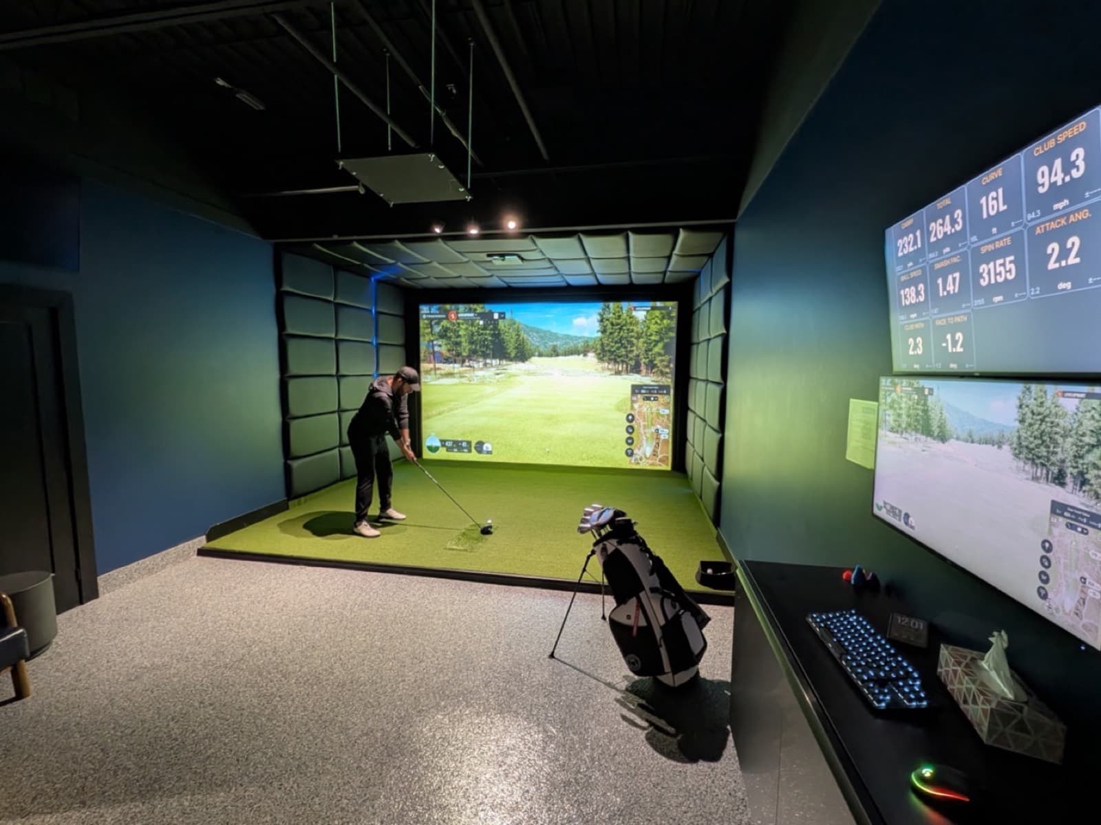 A player teeing off in a private Trackman iO bay