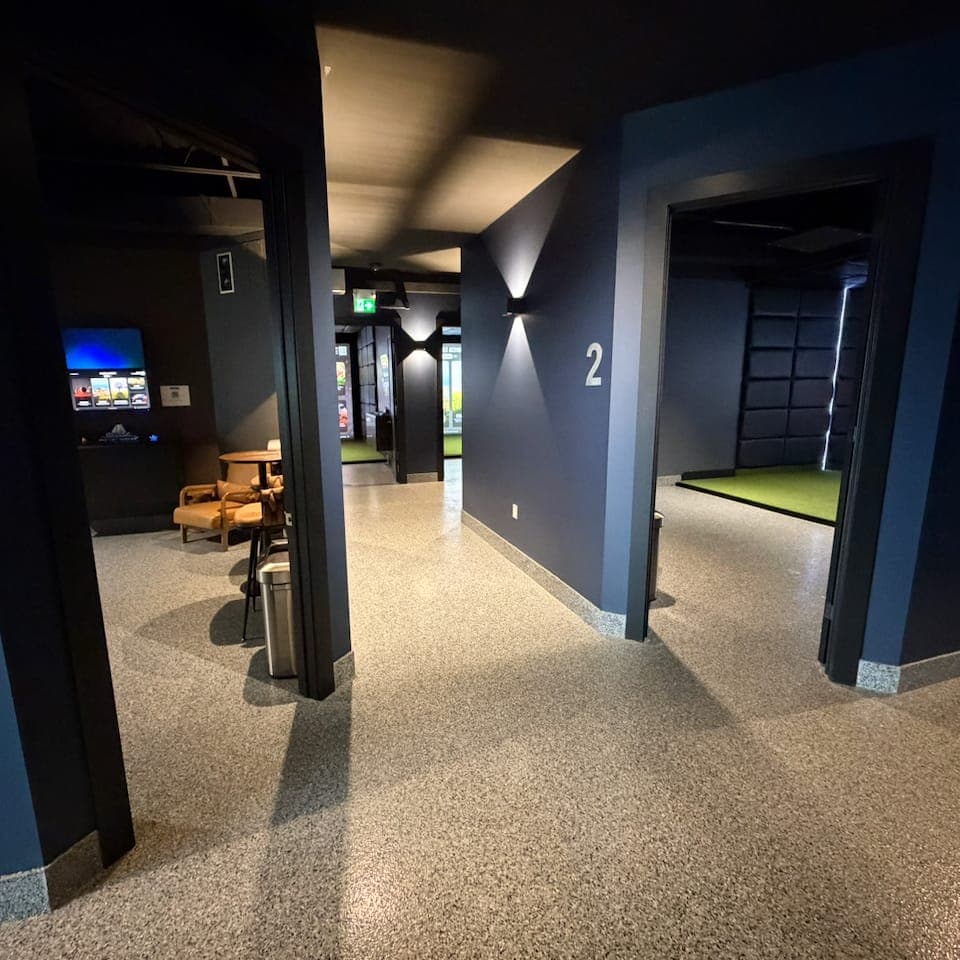 Lounge seating and private bay entrances at LevelUp Indoor Golf in Stoney Creek